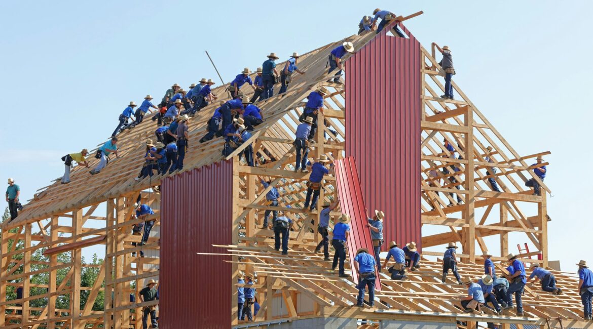 people building structure during daytime