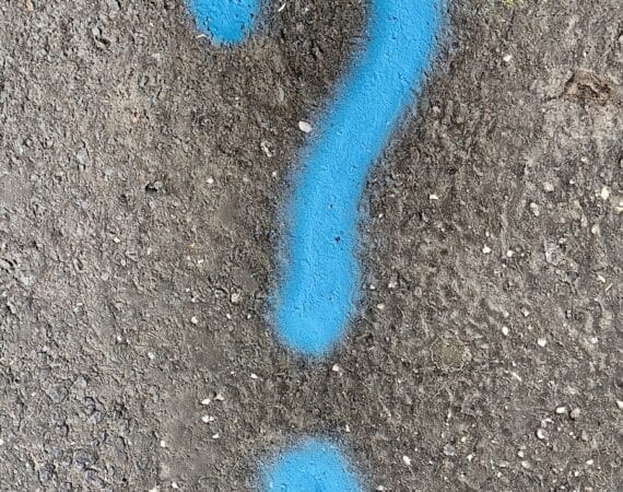 a blue question mark painted on the ground